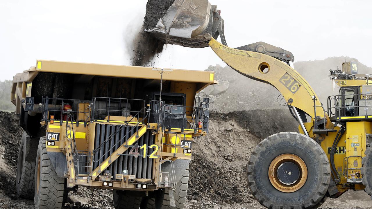 Mining trucks go about their work. (Image/Josh Woning)