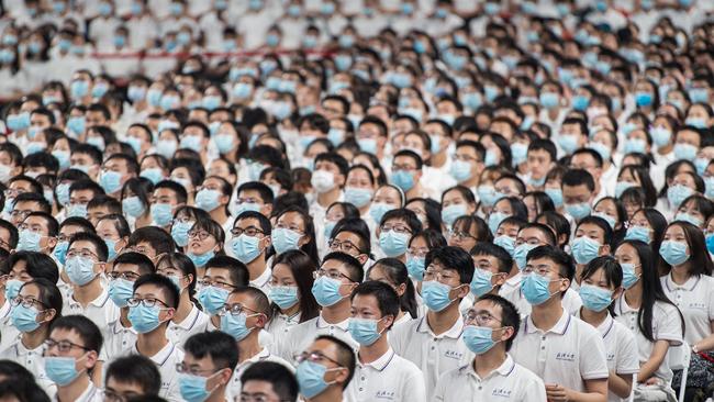 This photo taken on September 26, 2020 shows first-year students wearing masks as a preventive measure against the Covid-19 coronavirus during a commencement ceremony at Wuhan University in Wuhan, in China's central Hubei province.