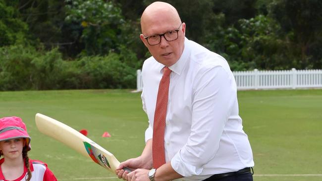 BRISBANE, AUSTRALIA - NewsWire Photos SEPTEMBER 19, 2024: The Leader of the Opposition Peter Dutton bats as Olivia, 7, looks on during a visit to the Valley District cricket club in Ashgrove. Picture: NewsWire/Tertius Pickard