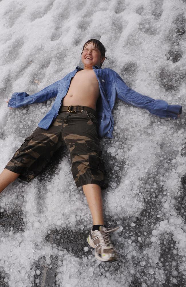 A Southbank visitor makes a hail angel following wild storms.