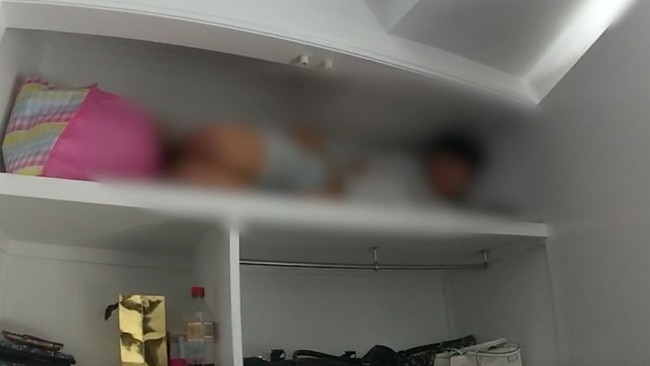 Footage released by police shows the teenagers hiding in cupboards during their arrest.