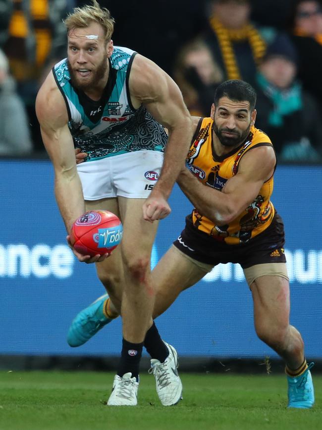 Jack Hombsch of the Power is tackled against Hawthorn this year. The defender fell out of favour later in the season. Picture: Scott Barbour/Getty Images