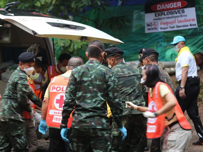 Thai soldiers and paramedics assist a rescued boy on a stretcher to an ambulance near the cave. Picture: AFP Photo / CHIANG RAI PUBLIC RELATIONS OFFICE