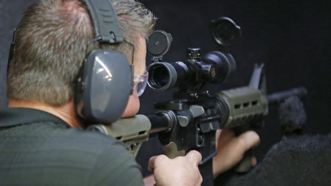 David Barker test fires an AR-15 semiautomatic gun at Action Target in Springville, Utah. Picture: George Frey