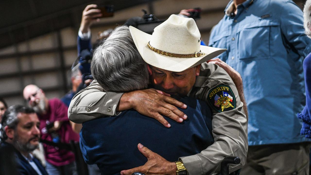 Uvalde County Sheriff Ruben Nolasco hugs Texas Governor Greg Abbott as they attend a vigil for the victims. Picture: AFP