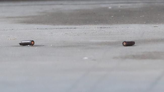 Bullet shells litter the driveway outside the home. Picture: David Crosling