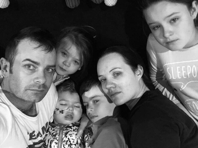 The Haevecker family of Bahrs Scrub, in Logan give Mason, 2, some final cuddles in bed after waking to find him not breathing. Picture: Mason's Journey/Facebook