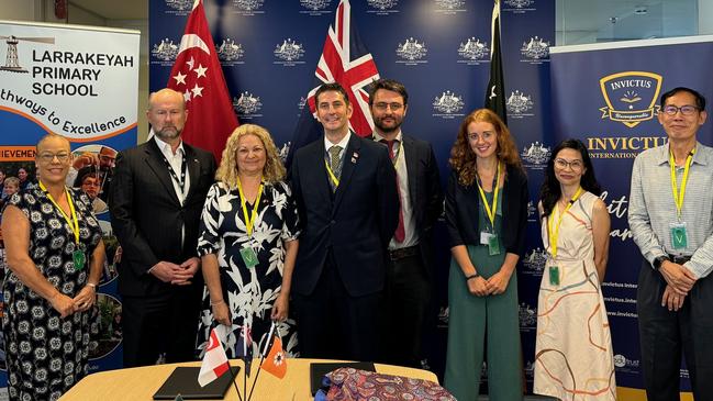 Larrakeyah Primary School principal Fathma Mauger and assistant principal Natasha Guse, along with High Commissioner Allaster Cox at the Sister School MOU signing with Invictus International School in Singapore.