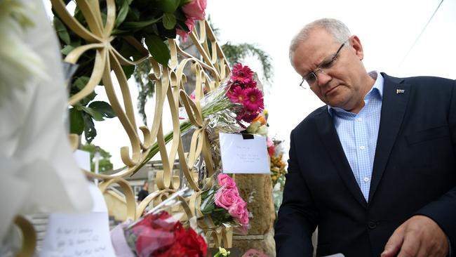 Prime Minister Scott Morrison looks at floral tributes to the victims of the Christchurch terror attack during a visit to the Lakemba Mosque, in  Lakemba, in south west Sydney, Saturday, March 16, 2019. The Prime Minster met with Islamic community leaders following the terror attack in Christchurch, New Zealand. (AAP Image/Dan Himbrechts) NO ARCHIVING