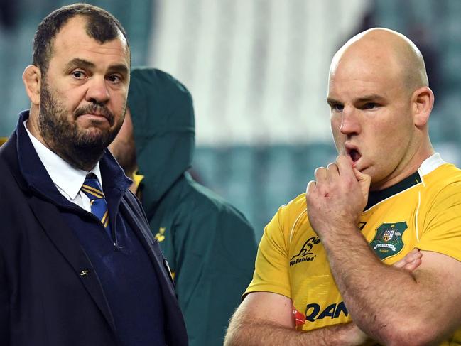 Australian rugby coach Michael Cheika (L) and captain Stephen Moore (R) talk after their loss to England in the third and final rugby union Test match in Sydney on June 25, 2016. / AFP PHOTO / WILLIAM WEST