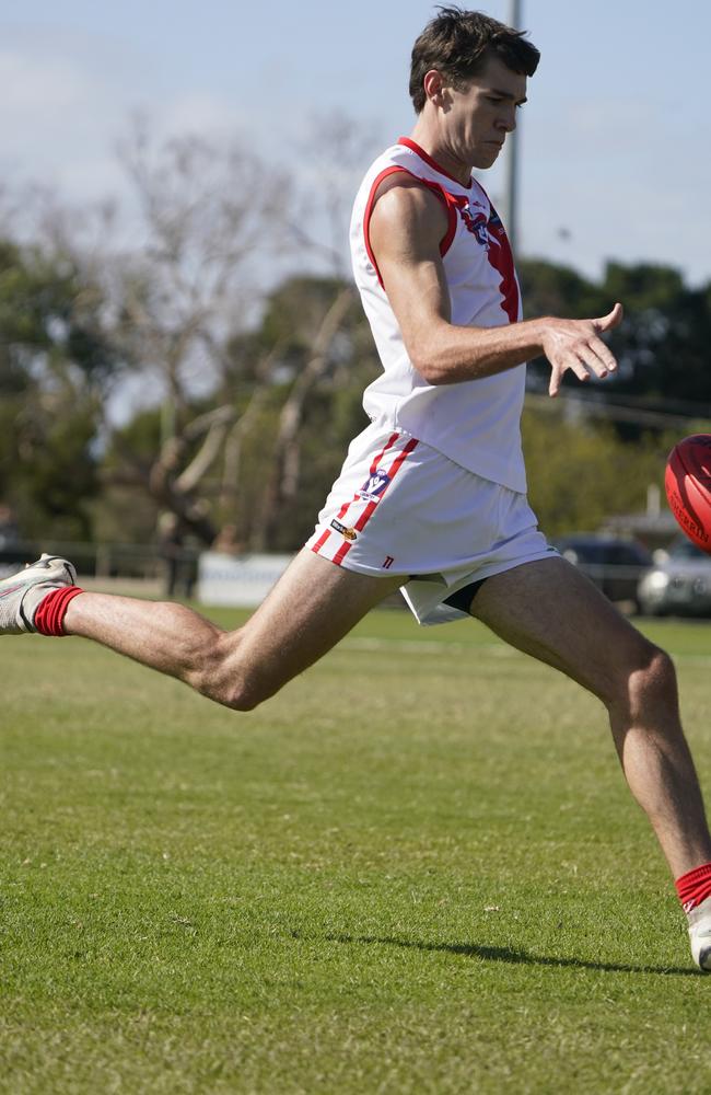 Teddy Banks takes a kick for Karingal. Picture: Valeriu Campan