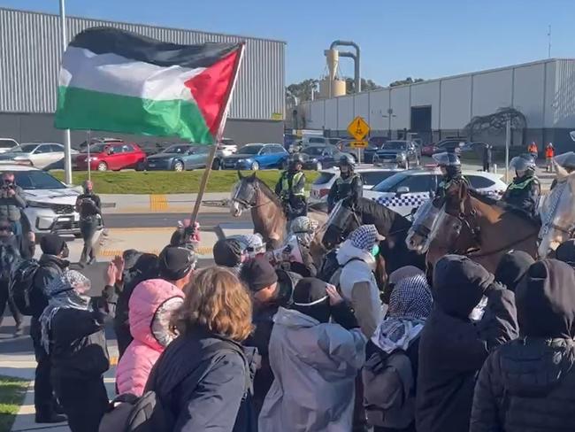 Pro-Palestine protestors square off against police outside a Dandenong South factory. Picture: Fergis Ellis