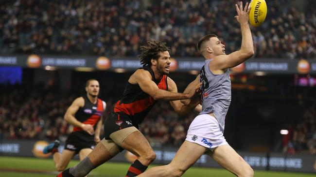 Peter Ladhams of the Power leads Essendon's Zac Clarke to the ball. Picture: Michael Klein