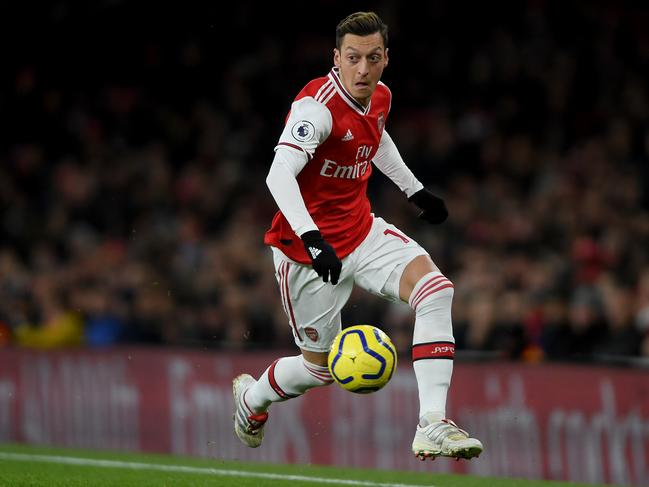 LONDON, ENGLAND - DECEMBER 05: Mesut Ozil of Arsenal runs with the ball during the Premier League match between Arsenal FC and Brighton & Hove Albion at Emirates Stadium on December 05, 2019 in London, United Kingdom. (Photo by Mike Hewitt/Getty Images)