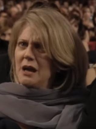 Mother Blythe Danner watches on.