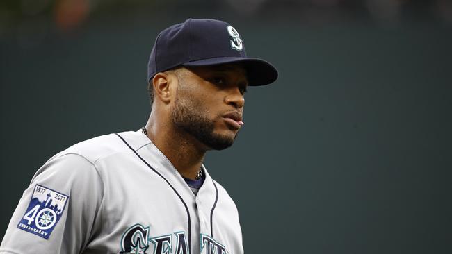 FILE - In this Aug. 28, 2017, file photo, Seattle Mariners' Robinson Cano walks on the field before a baseball game against the Baltimore Orioles in Baltimore. Cano has been suspended 80 games for violating baseball's joint drug agreement, the league announced Tuesday, May 15, 2018. (AP Photo/Patrick Semansky, File)
