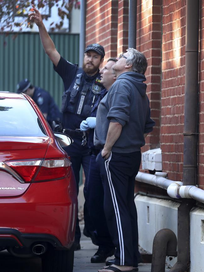 Police talk to neighbours after Burdon’s rooftop stand-off. Picture: AAP Image/Dean Martin