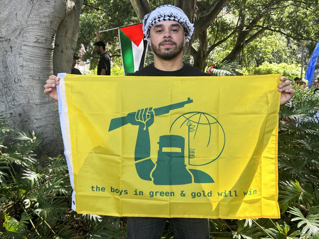 Sydney protester Alex said he was simply a “sporting enthusiast” who was “supporting the green and gold” when displaying a banner that appeared similar to the Hezbollah flag on Sunday. Picture: News Corp