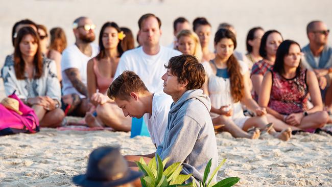 Today’s tribute began with meditation on the beach. Picture: Monique Harmer