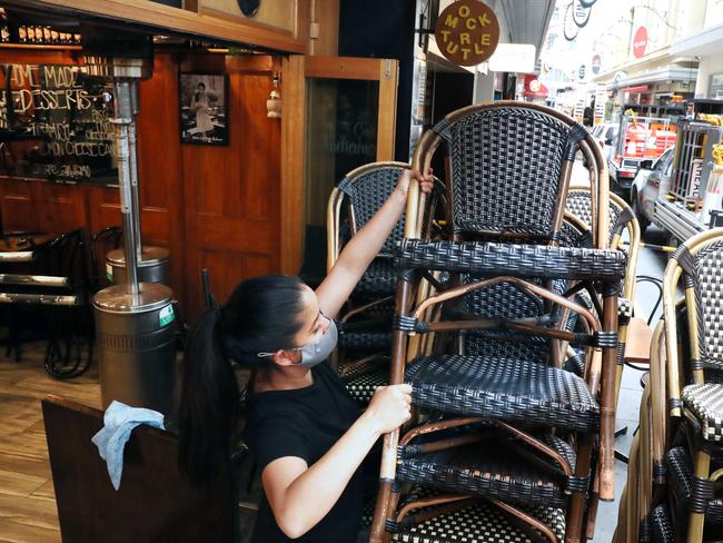 A worker sets up a cafe in Degraves St in the CBD as Victoria races towards its vaccine targets. Picture: David Crosling