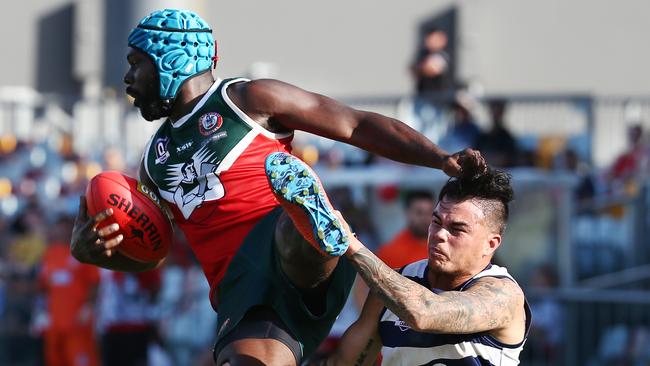 South Cairns' Dwayne Bosen is tackled mid air by Port Douglas' Kurt Bradshaw in the AFL Cairns men's grand final match between the Port Douglas Crocs and the South Cairns Cutters, played at Cazalys Stadium. PICTURE: BRENDAN RADKE