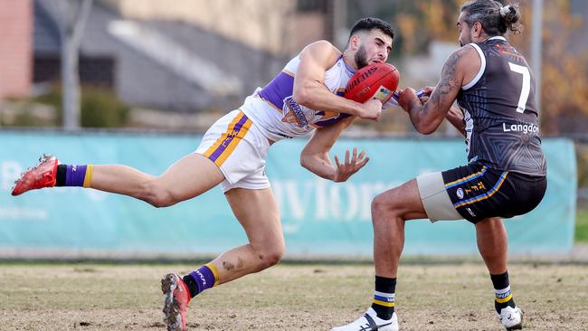 WRFL: Altona’s Saad El-Hawli is caught by Courtenay Dempsey of Caroline Springs. Picture: George Salpigtidis