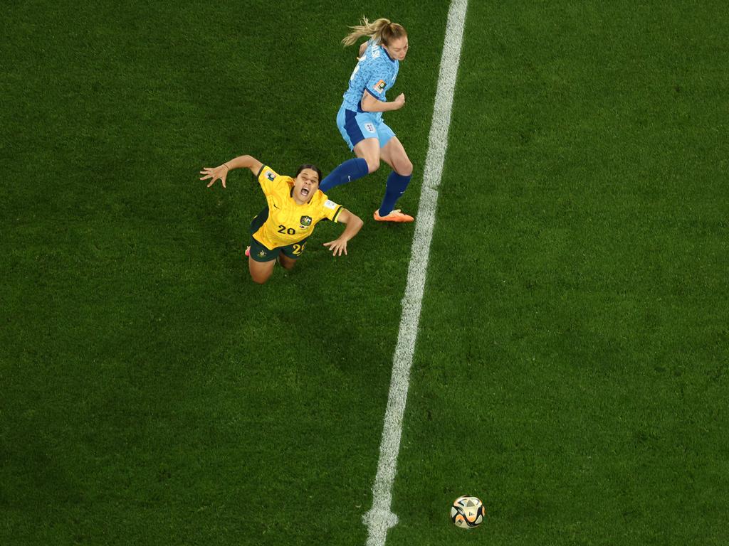 Sam Kerr is crunched by England midfielder Keira Walsh. Picture: DAVID GRAY/AFP