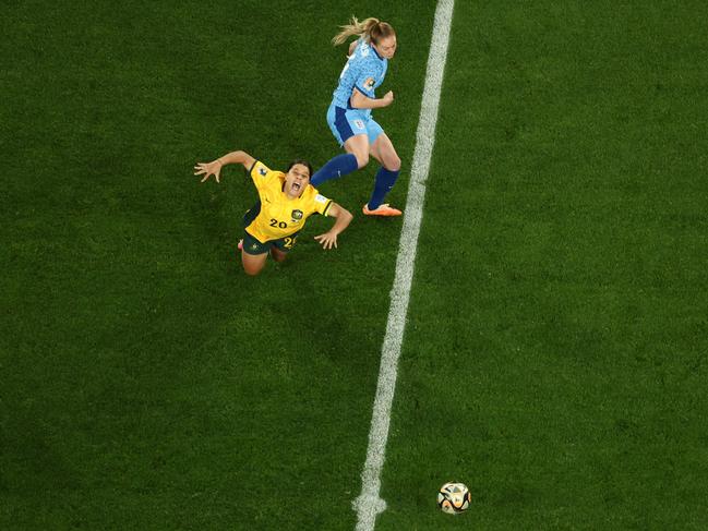 Sam Kerr is crunched by England midfielder Keira Walsh. Picture: DAVID GRAY/AFP