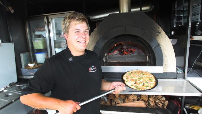 Flamecake chef, Markus Schulz with a Nordic Flammkuchen in front of his wood fired oven