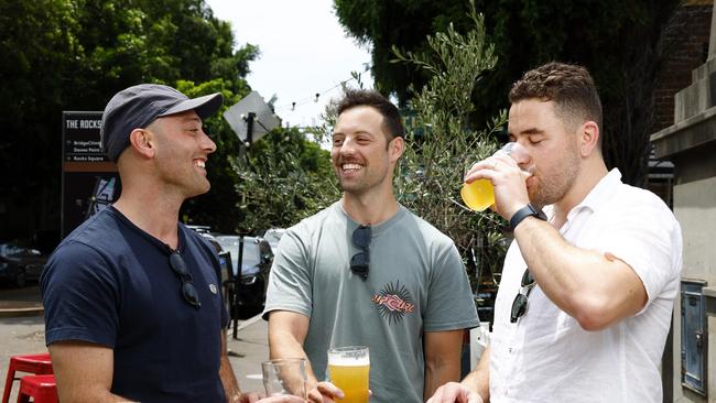 From left Adam Dekleva, 31, Ben Halligan, 31, and Tom Gaudiosi, 31, enjoying a beer at The Glenmore Hotel in The Rocks. Picture: Jonathan Ng