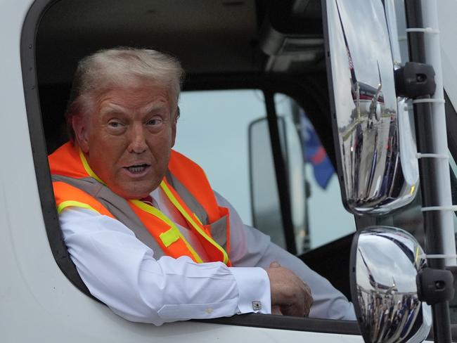 Republican presidential nominee former President Donald Trump talks to reporters as he sits in a garbage truck Wednesday, Oct. 30, 2024, in Green Bay, Wis. (AP Photo/Julia Demaree Nikhinson)