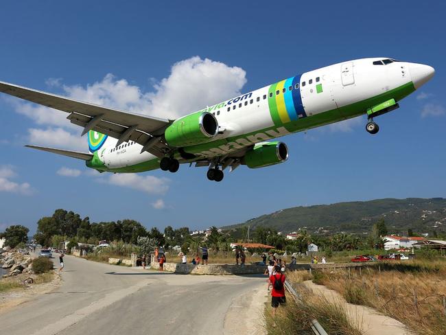 A passenger jet flies low to the ground over the Greek island of Skiathos, where the local airport is a popular plane-spotting location. Picture: Wikimedia Commons Timo Breidenstein