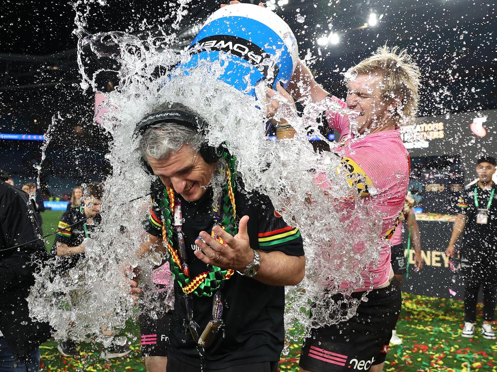 Panthers coach Ivan Cleary copped a spontaneous soaking as players celebrated their premiership win. Picture: Cameron Spencer/Getty Images