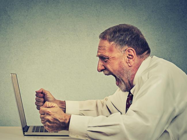 Angry furious senior business man working on computer, screaming. Negative human emotion facial expression feeling aggression anger management issues concept. Side profile guy having nervous breakdown