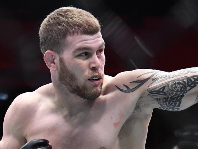 LAS VEGAS, NEVADA - MARCH 06: (L-R) Jake Matthews of Australia punches Sean Brady in their welterweight fight during the UFC 259 event at UFC APEX on March 06, 2021 in Las Vegas, Nevada. (Photo by Chris Unger/Zuffa LLC)