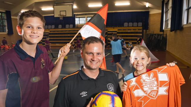 Toowoomba Anglican School students Hayden Johnston and Olivia McNicol talk football with Brisbane Roar Academy general manager Warren Moon earlier this year.