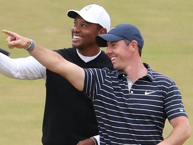 ST ANDREWS, SCOTLAND - JULY 11: Tiger Woods of The United States and Rory McIlroy of Ireland interact on the 18th during the Celebration of Champions Challenge during a practice round prior to The 150th Open at St Andrews Old Course on July 11, 2022 in St Andrews, Scotland. (Photo by Warren Little/Getty Images)