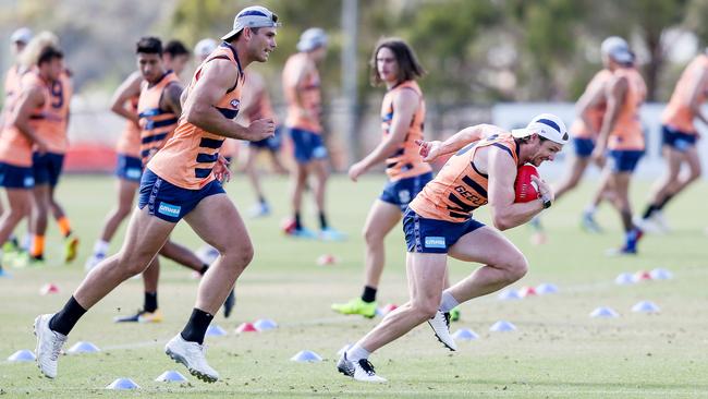 Tom Hawkins tries to keep up with team-mate Patrick Dangerfield at Geelong training.