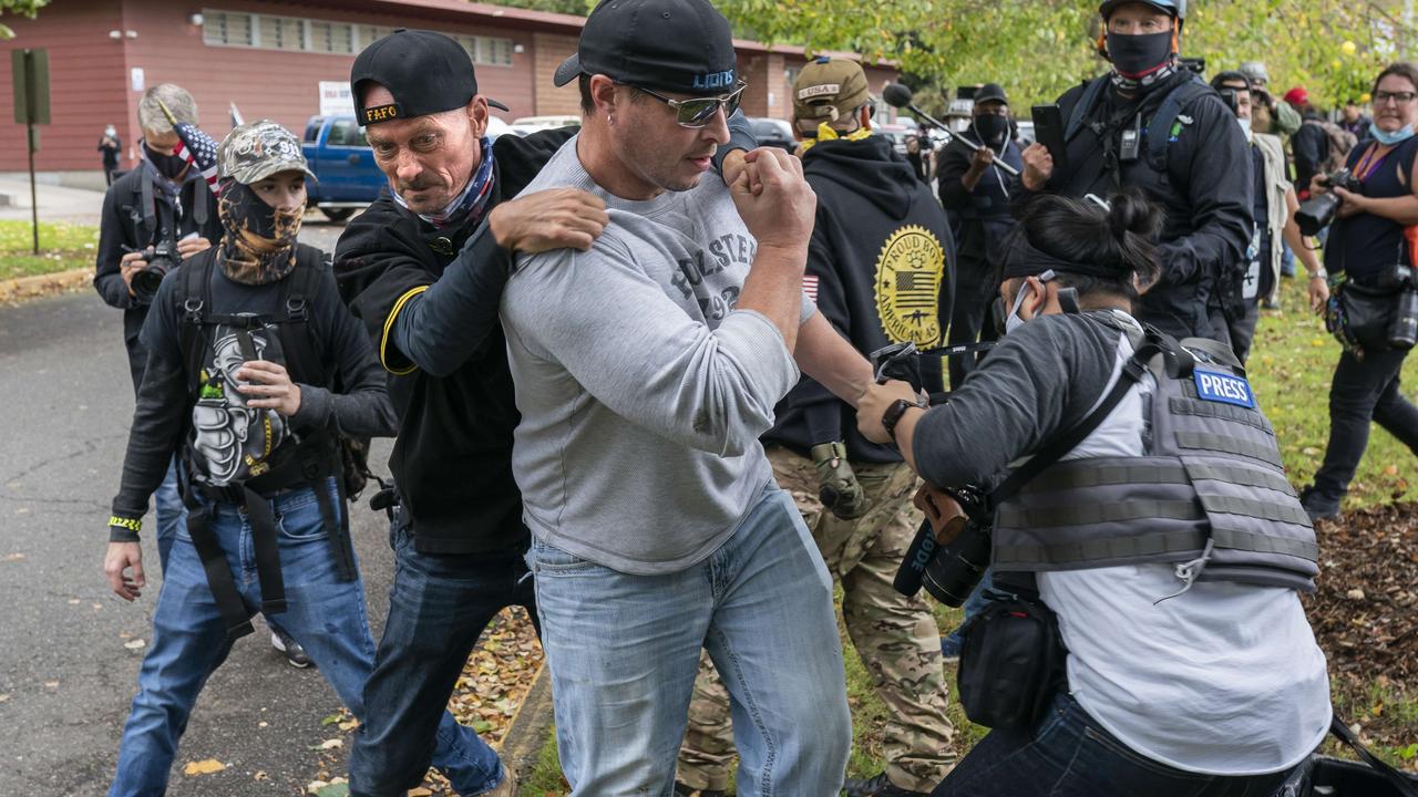 A member of the Proud Boys tackles a fellow member after he assaulted freelance journalist Justin Katigbak (right) during a Proud Boy rally on September 26 in Portland, Oregon. Oregon Governor Kate Brown declared a state of emergency prior to Saturday’s rally as fears of political violence between Proud Boys and Black Lives Matter protesters grew. Picture: Nathan Howard/Getty Images/AFP