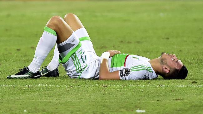 Algeria's defender Rami Bensebaini reacts to the loss.