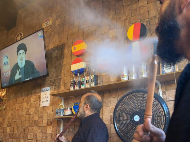 People watch the televised speech of Lebanon's Hezbollah chief Hasan Nasrallah at a cafe in Lebanon's southern city of Nabatiyeh. Picture: AFP