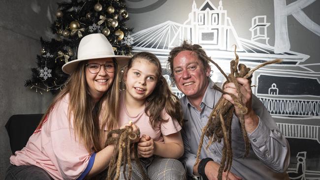 Shannon and Joel Anderson with their daughter Charlise after Joel's dreadlocks are cut off in a fundraiser for Charlise at the Blue Mountain Hotel, Saturday, November 23, 2024. Picture: Kevin Farmer