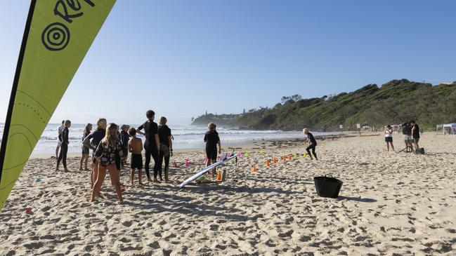 Surfers readying to enter the waves at the Reflections Cadet Cup at Bonny Hills.
