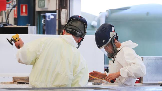 Workers at La Rocca Marble and Granite are protected from potentially deadly silica dust with government-approved PPE gear. Photo: Scott Powick