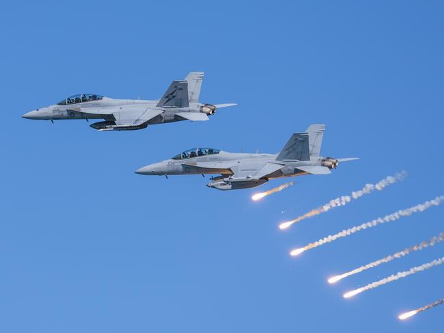 An Air Force F/A-18F Super Hornet and EA-18G Growler fly in formation during a handling display at Nobby's Beach, as part of the Newcastle Williamtown Air Show 2023. *** Local Caption *** The Royal Australian Air Force (RAAF) in partnership with the City of Newcastle and Port Stephens Council delivered the Air Force Newcastle Williamtown Air Show 2023 over the weekend of 18 and 19 November 2023. The free community event on Saturday 18 November included morning and afternoon flying displays by RAAF aircraft overwater of Newcastle beaches and rivers. On Sunday 19 November, RAAF Base Williamtown opened its gates for an Open Day featuring static ground displays and a range of military equipment from across the Australian Defence Force. Newcastle Williamtown Air Show was proudly presented to continue to build on the relationship between Air Force and the local RAAF Base Williamtown community.