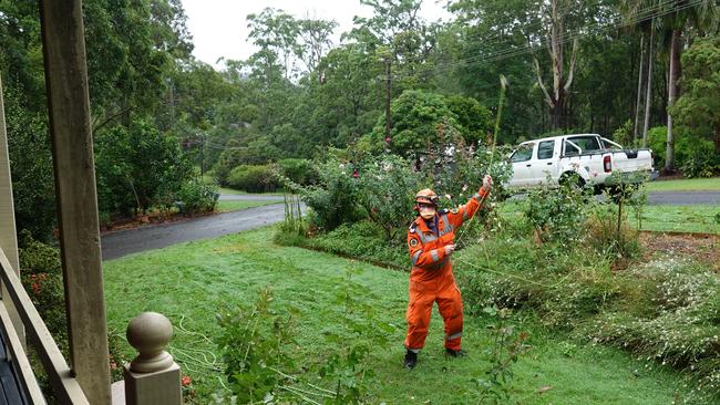 SES volunteer Keith Haycraft launches a rope safety line across a roof at a house in Symons Ave, Boambee. Picture: Chris Knight