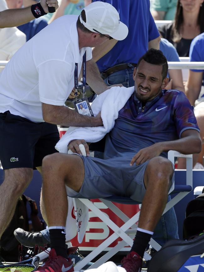 Trainer Paul Ness, left, works on Nick Kyrgios’ injured shoulder.