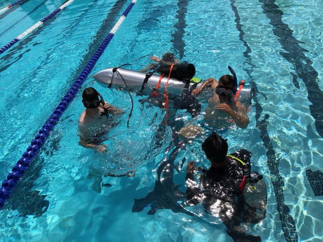 Divers test the device Elon Musk took to Thailand in a pool in Los Angeles. Picture: Elon Musk/Supplied