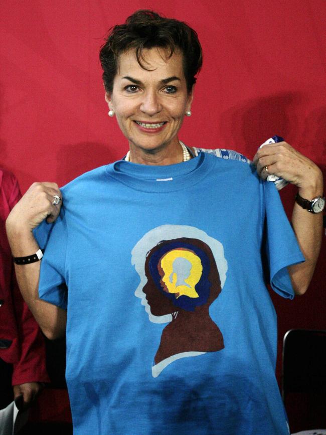 Christiana Figueres poses with a T-shirt from the International Youth Climate Organisation during the UN Climate Change Conference in Cancun, Mexico.