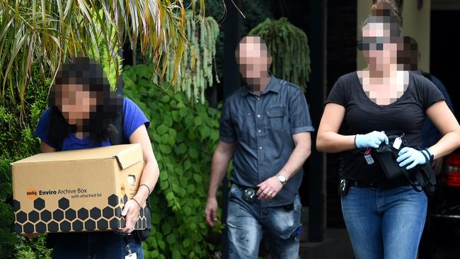 IBAC officers seize evidence in raids related to the alleged printing rort. Picture: Nicole Garmston